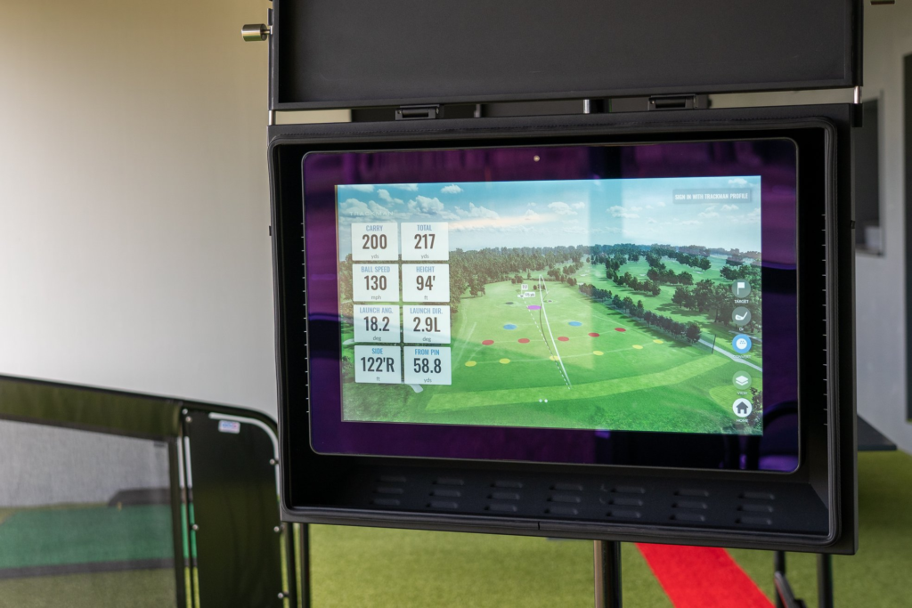 TrackMan iO golf simulator setup with impact screen and projector